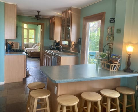 The sunny kitchen is completely equipped for your stay; family room is beyond