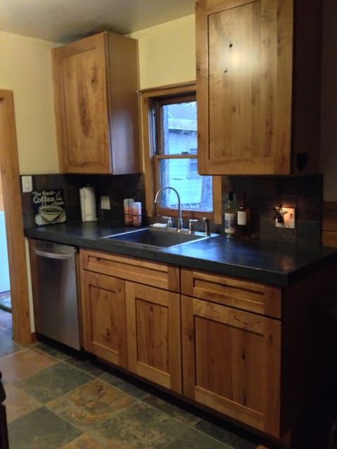 Kitchen with dishwasher  and looks out to backyard 