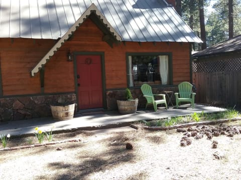 Photo of front porch with seating out front and large picture window