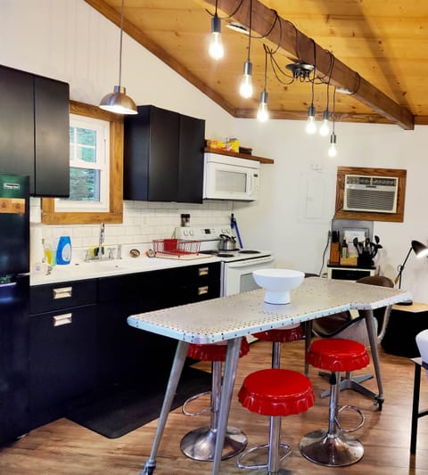Well stocked kitchen with vintage airplane wing table!