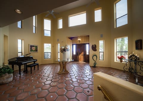 Formal entry gallery with piano, local art and sculpture