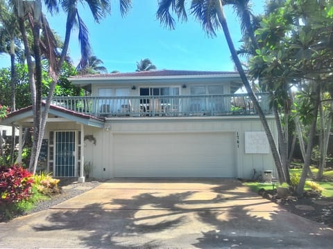 Front of the house with large deck over the garage.
