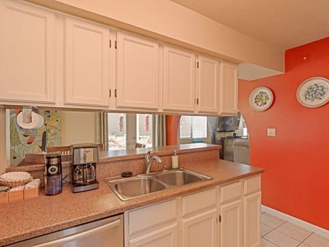 The cook has a view of the garden and people at the dining table