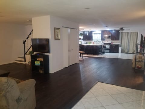 View from front door.  Hard wood flooring. Shows steps to upstairs on the Left