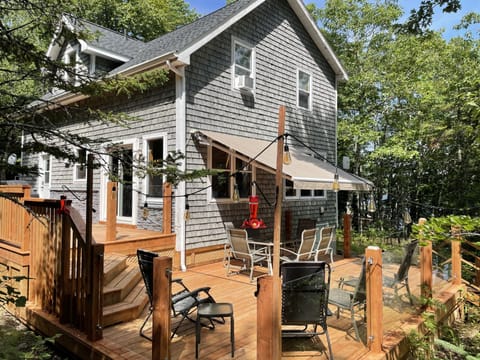 Cozy cottage with large wrap-around deck and awning