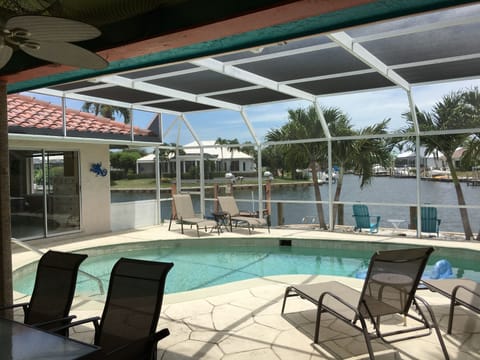 Relaxing lanai, south facing heated pool, backyard beach, beautiful water view!