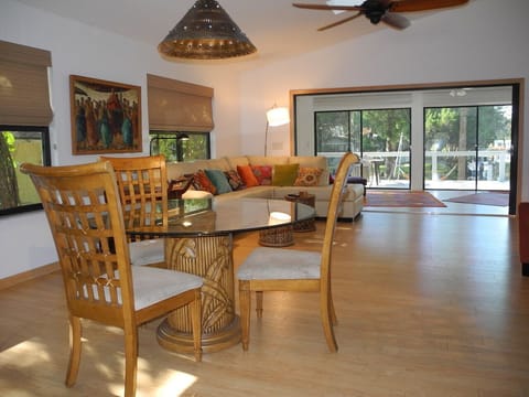View through diningroom, livingroom, sunroom, & piece of deck, dock, $ water.