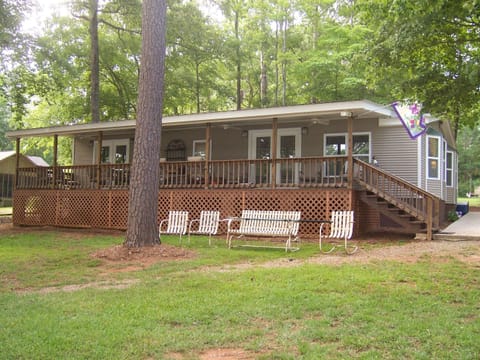 Front of cottage showing two French doors that open onto expansive porch, good for viewing the 175 feet water front lot, the front porch has enough seats for twelve.