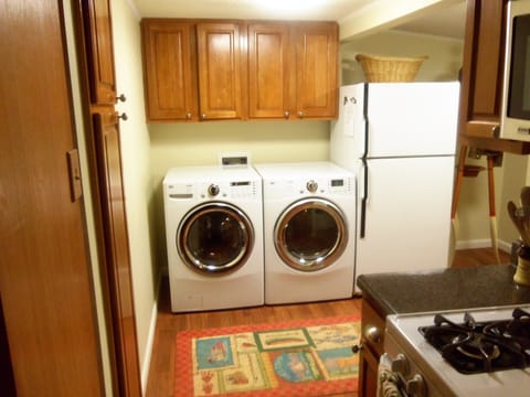 Back entry with washer, dryer, and extra second refrigerator. 