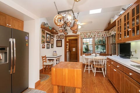 Seating for six around breakfast table. Kitchen opens to back deck  and garage. 