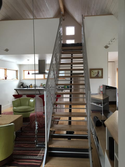 The stairs to the loft in the down position.  Looking from the hall/laundry.  