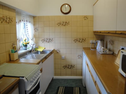 Kitchen with fridge [freezer compartment] and microwave