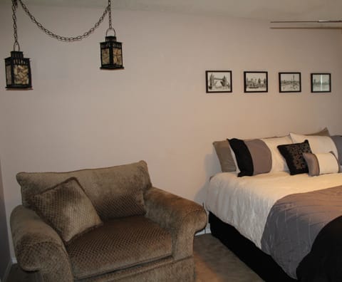 King size bed, love seat, dresser, closet, and slider to yard.