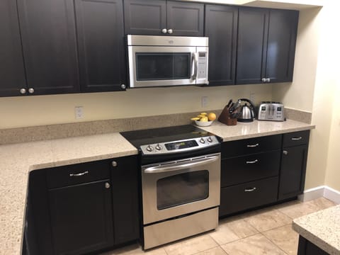 Updated Kitchen With Stainless Steel Appliances And Quartz Countertops