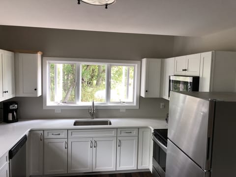 Kitchen with dishwasher, coffee maker and toaster.
