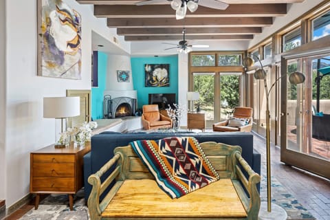 The living room has a wood burning Kiva fireplace and a fold-out sofa bed.