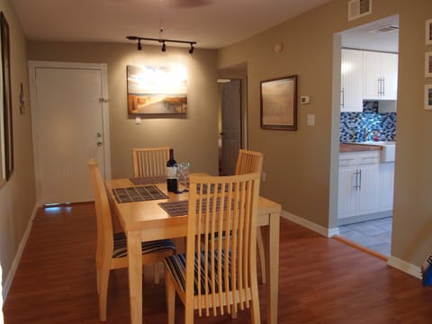 Dining room and kitchen. The back door on the right leads into bedroom.