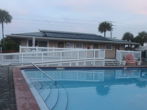 Condo clubhouse with bathrooms, plenty of chairs & tables for relaxing poolside!