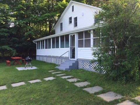 Picnic table and grill below porch