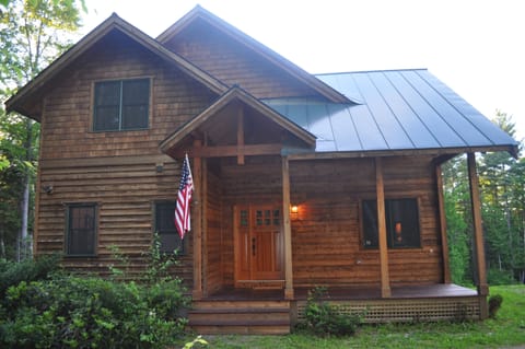 Another view of the front of the home and the front porch in the summer.