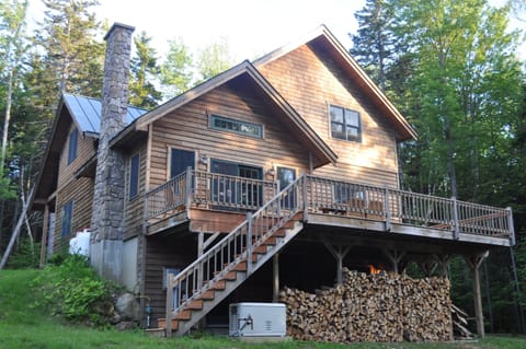 The back of the home in the summer.