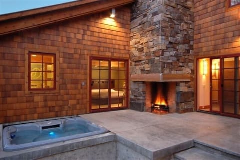 hot tub and outdoor fireplace