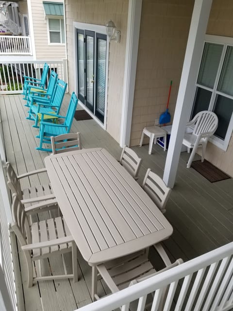large deck with ocean views, plywood rockers and dining furniture!