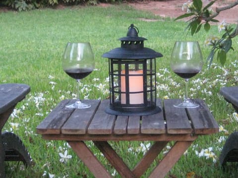 Enjoy a glass of wine during the early evening, surrounded by fragrant frangipan