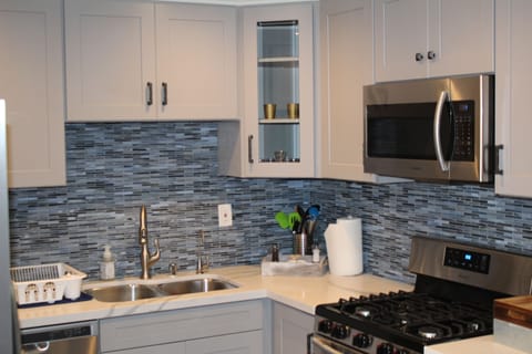 Completely brand new cabinets, back splash, microwave, countertops  and stove