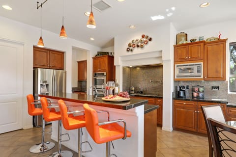 Chefs kitchen with bar seating for 4 and casual dining for 6