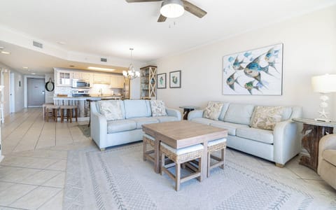 Inviting living area with comfortable seating, sofa with queen sleeper, a stylish coffee table, and coastal-themed decor