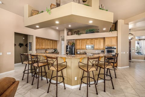 Seating for 6 at kitchen counter. Hall leads to Bedrooms 2 & 3