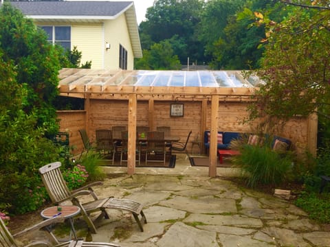 Lovely landscaped yard with outdoor dining and comfy lounging area.