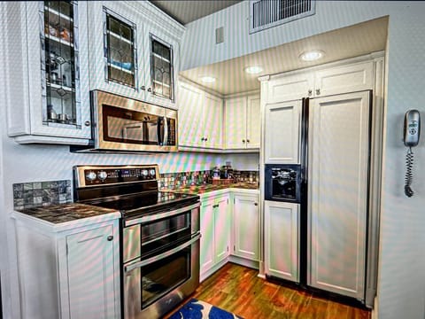 Kitchen stove and refrigerator area.