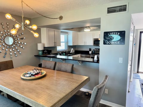 Large counter height dining table with 4 chairs and a bench