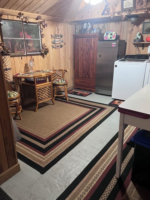 Washer and dryer and detergent. Located across back deck with  second bathroom .