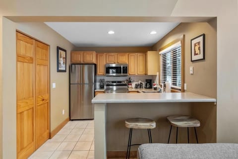 Updated kitchen - The upper level kitchen, one of two in the condo, has stainless steel appliances and all that you'll need to dine and cook.