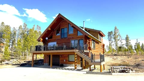 Log cabin on 3 acres with large paved driveway, deck and picnic area.