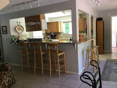 Open kitchen with eating bar.