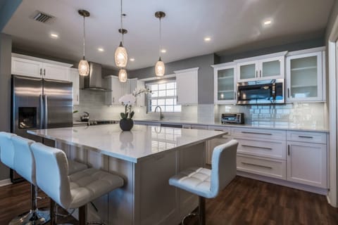 Kitchen view with a lovely aisle for dining. 