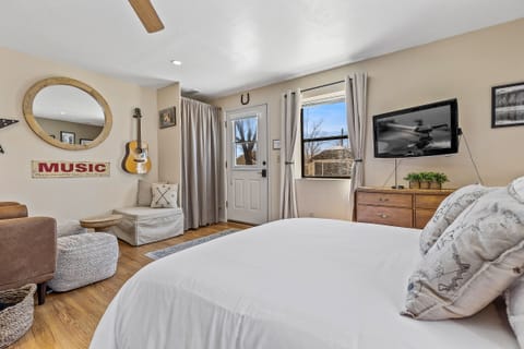 *NEW Queen bed looking on to the living area.