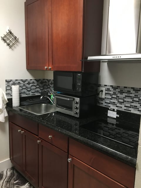 Kitchenette with microwave, toaster oven, and built in cooktop.