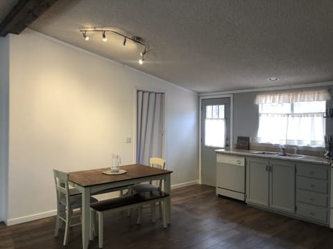 Dining room table, laundry room, and back door.