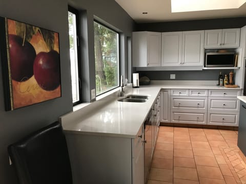 Brand new quartz countertops in huge upstairs kitchen with stunning ocean view.