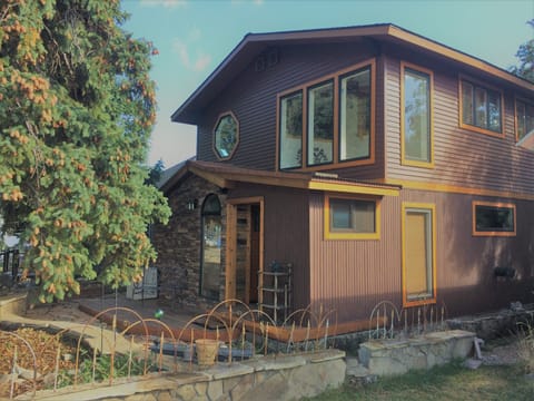 Look for the house behind 2 Big Spruce trees