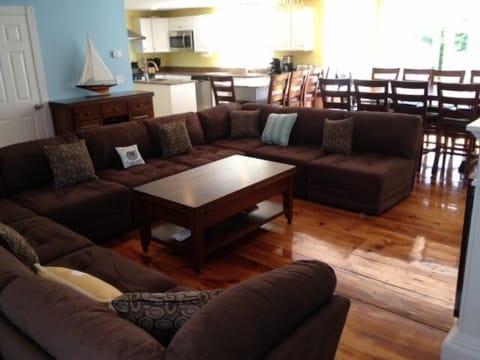 Living room, sofa seating 12-14, huge open floor layout, 1800s wide pine floor.