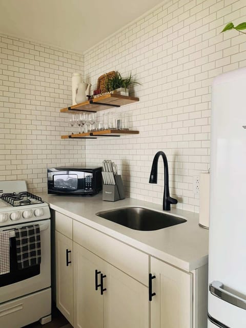 Upstairs Kitchen- Fully stocked kitchen with everything you need to cook, snack, or sip.