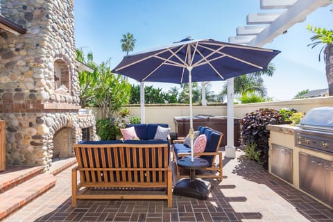 Entertainment area complete with spa, barbeque, patio furniture, fireplace...