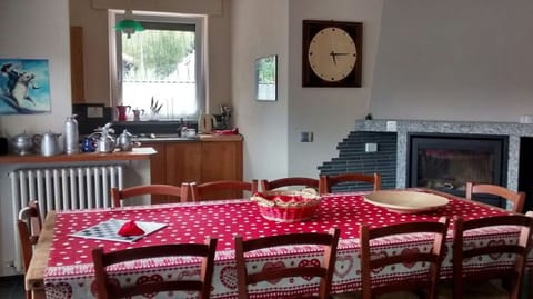 The big table in the living room with 12 seats