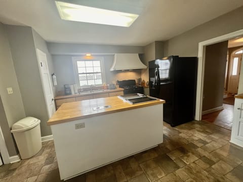 kitchen with island, microwave, refrigerator, gas range, dishwasher